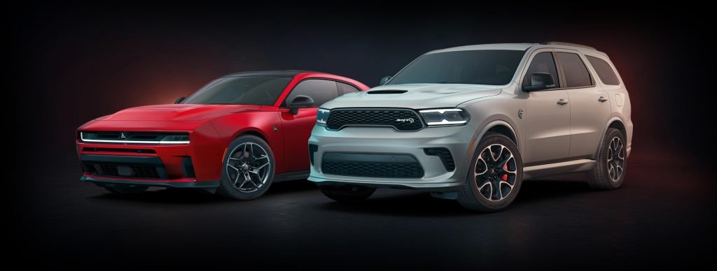 A red sports car and white SUV are parked side by side on a dark background, highlighting vehicle contrast.